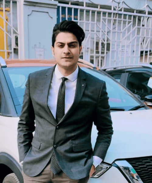 Professional man in suit standing outdoors near car, representing reliable cleaning services.